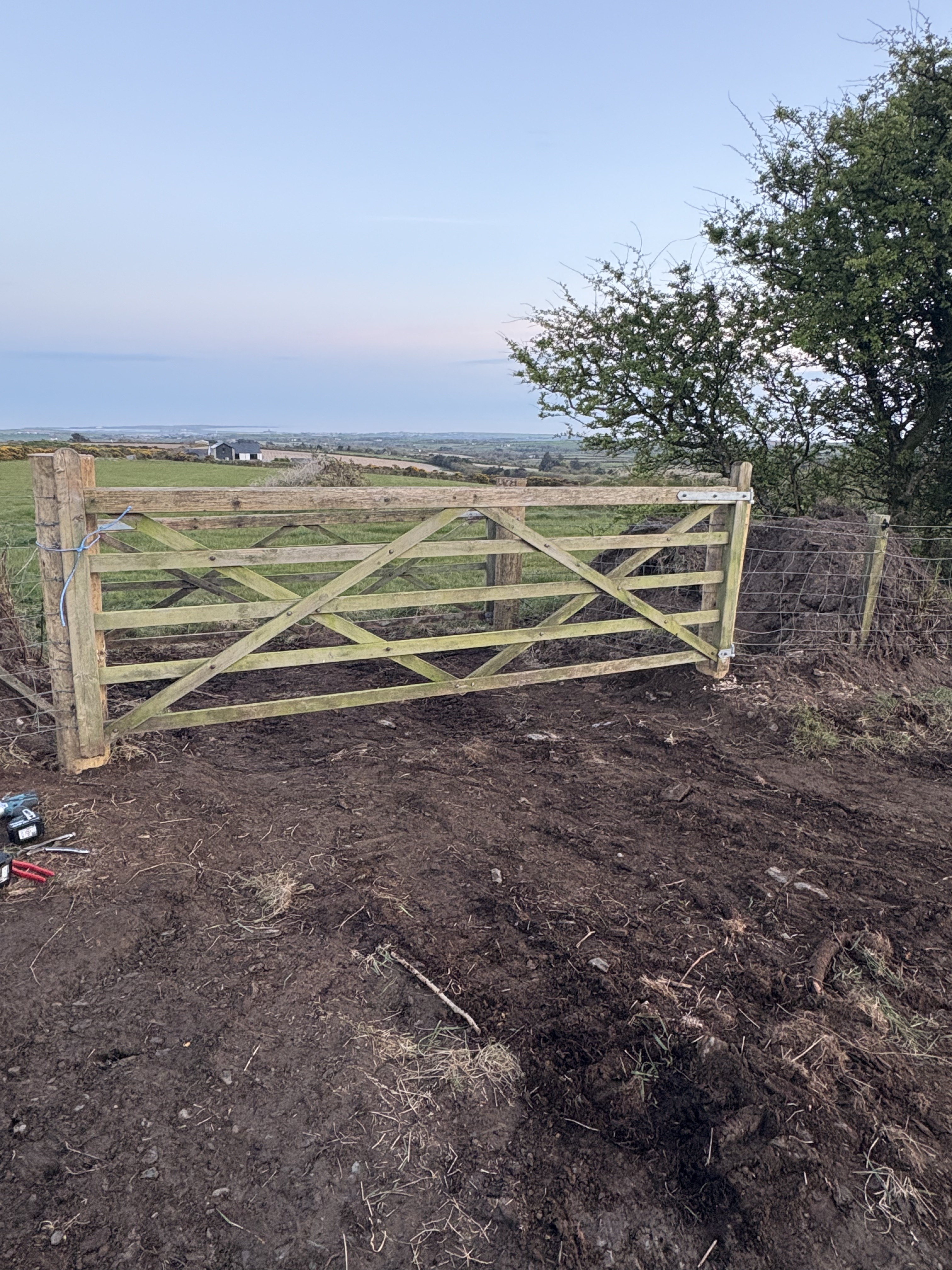 Gate post installation using tracked post driver on-site